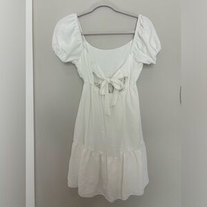 White dress. Puffy sleeve. Bow back.